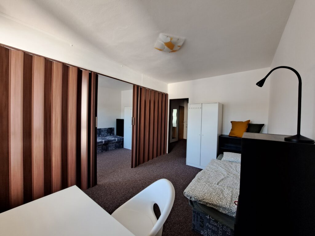 Accommodation for students in Brno on Myslivní. Room for two with balcony. Roller shutter door inside the room.